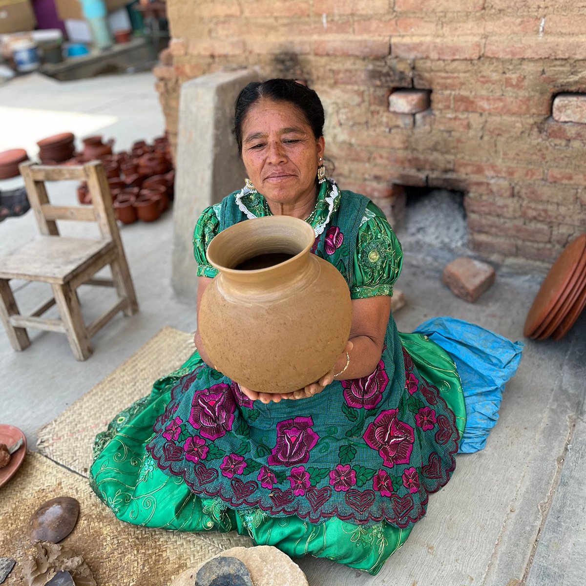 Macrina enjoying her handmade red clay pot in San Marcos Tlapazola