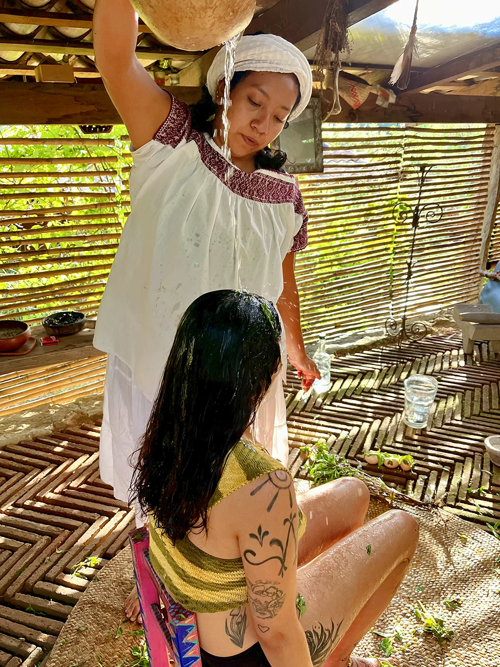Yannely cleansing with water at Rancho Media Luna
